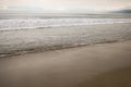 Ocean waves on Santa Monica beach in cloudy november day Royalty Free Stock Photo