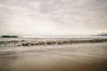 Ocean waves on Santa Monica beach in cloudy november day Royalty Free Stock Photo