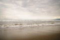 Ocean waves on Santa Monica beach in cloudy november day Royalty Free Stock Photo