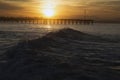 Ocean waves at sunrise with Ventura Pier, Ventura, California, USA