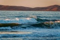 Ocean waves at sunset and mountains on background  California Royalty Free Stock Photo
