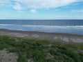 Ocean waves touching the coastline with the green field view, Playa El Espino, Usulutan, El Salvador