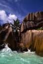 Ocean waves washing over smooth volcanic rocks