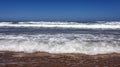 Oceanic long wave on a sandy beach Royalty Free Stock Photo