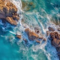 Oceanic Majesty: Aerial View of Waves Clashing Against Majestic Cliffside Rocks