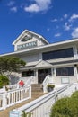 The Oceanic Restaurant with people sitting in the window surrounded by lush green trees, colorful flowers Royalty Free Stock Photo