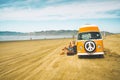 Vintage yellow van on the beach with cloudy sky on background, retro color effect. Oceano Dunes, California Central Coast Royalty Free Stock Photo