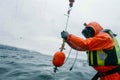 Oceanographer Deploying Weather Buoy at Sea. Generative ai