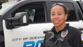 Oceanside, CA / USA - October 27, 2019: A friendly young female police officer of mixed ethnicity