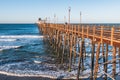 People Enjoy View From Oceanside Fishing Pier