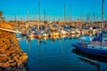 Oceanside Harbor is filled with boats and a lighthouse stands on guard in the background Royalty Free Stock Photo