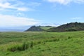 Oceanside landscape with a green rolling hill ranch along the road to Hana on the island of Maui Royalty Free Stock Photo
