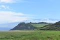 Oceanside landscape with a green rolling hill ranch along the road to Hana on the island of Maui Royalty Free Stock Photo