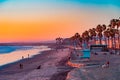 A Oceanside sunset at the beach draws people to it to walk and relax