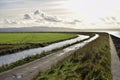 Oceanside walk wall rocks long grass road stream fields clouds sunshine