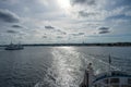 Ocean view towards Elsinore in Denmark from the aft of a boat. Backlit picture with blue ocean and blue sky