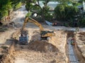 Construction underway for foundations of hotel development with large earthmover