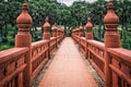 Ochre bridge leading to a garden at Rajapruek park in Chiang Mai, Thailand