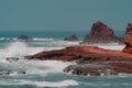 Ochre sandstone rock formations in Legzira Beach. Wild waters in Tiznit Province. Sea in Morocco, Africa. Atlantic Ocean waves.