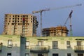 Construction site of apartment houses with cranes and scaffoldings