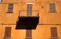 Ocre facade with balcony and shadow