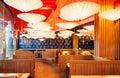 Vibrant Japanese restaurant interior, decorated ceiling with pap