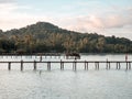 6 oct 20, Koh Kut Island, Thailand. workers walking on wooden bridge over the sea near tropical beach resort. sunrise in the morni Royalty Free Stock Photo