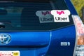 Oct 10, 2019 Mountain View / CA / USA - Lyft and UBER stickers on the rear window of a Toyota Prius Hybrid vehicle offering rides