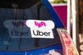 Oct 10, 2019 Mountain View / CA / USA - Lyft and UBER stickers on the rear window of a vehicle offering rides in San Francisco Bay