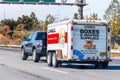 Oct 26, 2019 Mountain View / CA / USA - Semi truck towing an U-Haul cargo trailer, on a freeway in San Francisco bay area; U-Haul Royalty Free Stock Photo