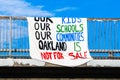 Oct 18, 2019 Oakland / CA / USA - Sign stating `Our kids Our Schools Our Communities Oakland is not sale` displayed on a bridge Royalty Free Stock Photo