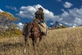 Older Cowboy leads packhorse across historic Last Dollar Ranch o