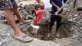 Worker operating a jackhammer to dig up a road for pipelining in Uttarakhand, India. Illustrating progress and development in