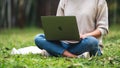 Oct 30th 2020 : A woman using Apple MacBook Pro laptop computer in the park , Chiang mai Thailand