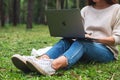 Oct 30th 2020 : A woman using Apple MacBook Pro laptop computer in the park , Chiang mai Thailand