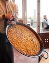 Hot Paella Spanish seafood fried rice in large iron pan serving in restaurant