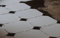 Octagon and dot tiles being laid in a hallway floor