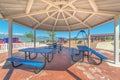 Octagon pavilion with blue picnic tables and view of lake and Mount Timpanogos