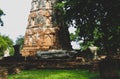 Octagonal Chedi and ruined Buddha figure at Wat Mahathat historical park, Ayutthaya, Thailand.
