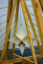 The octahedron hangs on wooden sticks