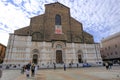 October 2021 Bologna, Italy: Facade of the basilica di San Petronio in the square, Piazza Maggiore across the blue sky and tourist Royalty Free Stock Photo