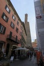 October 2021 Bologna, Italy: Via Clavature street Quadrilatero, tourists walking across the tower Royalty Free Stock Photo