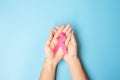 October Breast Cancer Awareness month, adult Woman  hand holding Pink Ribbon on blue background for supporting people living and Royalty Free Stock Photo