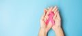 October Breast Cancer Awareness month, adult Woman  hand holding Pink Ribbon on blue background for supporting people living and Royalty Free Stock Photo