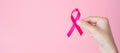 October Breast Cancer Awareness month, adult Woman hand holding Pink Ribbon on pink background for supporting people living and Royalty Free Stock Photo