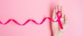 October Breast Cancer Awareness month, adult Woman hand holding Pink Ribbon on pink background for supporting people living and Royalty Free Stock Photo