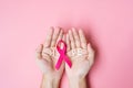 October Breast Cancer Awareness month, adult Woman hand holding Pink Ribbon on pink background for supporting people living and Royalty Free Stock Photo