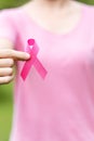 October Breast Cancer Awareness month, adult Woman in pink T- shirt with hand holding Pink Ribbon for supporting people living and