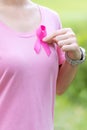 October Breast Cancer Awareness month, adult Woman in pink T- shirt with hand holding Pink Ribbon for supporting people living and Royalty Free Stock Photo