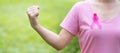 October Breast Cancer Awareness month, adult Woman in pink T- shirt and Pink Ribbon for supporting people living and illness.